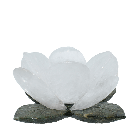 Clear quartz crystal lotus flower sculpture with translucent petals and green leaves base.