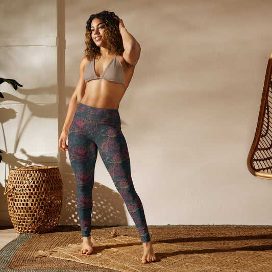 Yoga leggings with intricate floral pattern, worn by a person standing in a relaxed pose, in a light-filled room with wicker basket and chair.