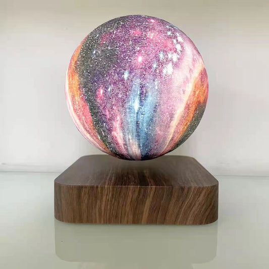Levitation moon lamp with colorful galaxy design placed on a wooden base.